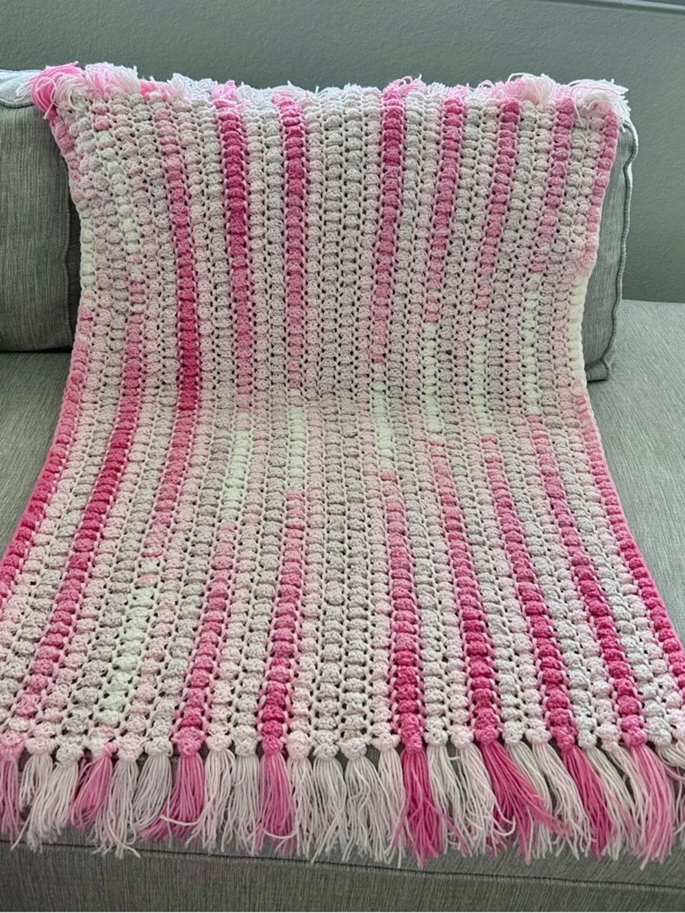Pink and light pink crocheted baby blanket